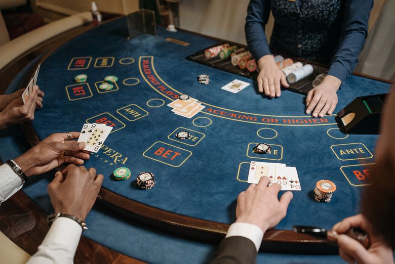 Kartu remi dibagikan dealer di meja kasino untuk promo rollingan poker
